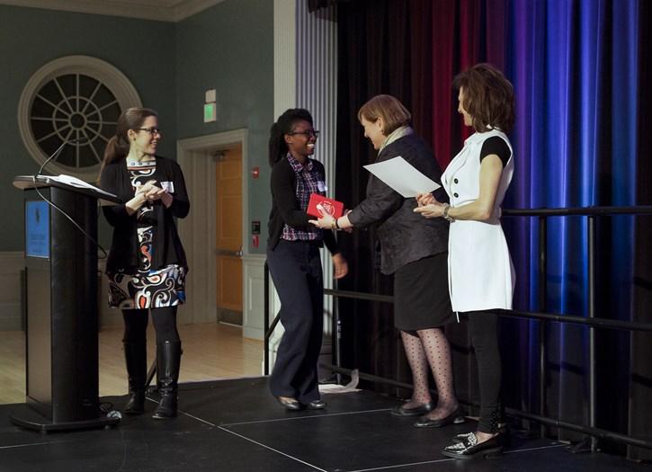 Woman receive award on stage