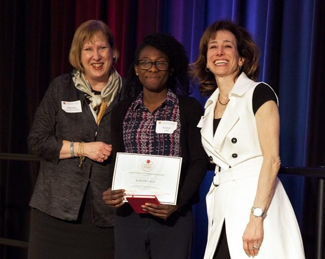 Woman receive award on stage