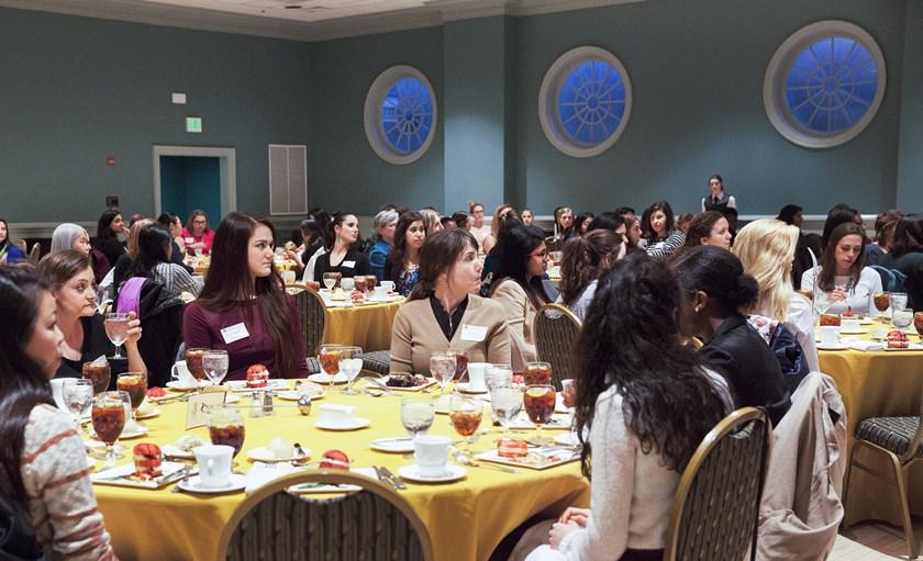 a large group of women sitting by tables