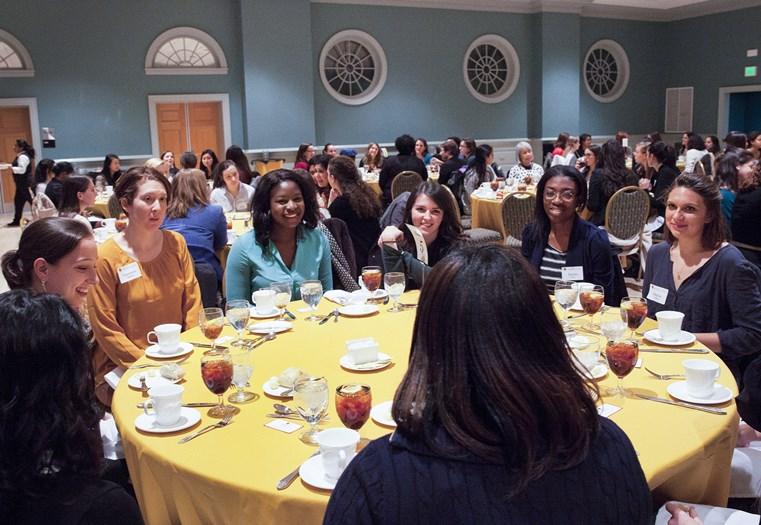 women sitting by table
