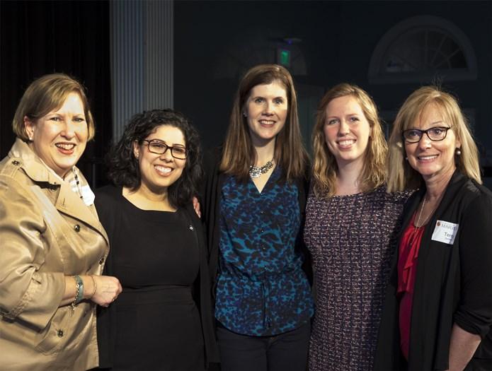 five women smiling in group photo